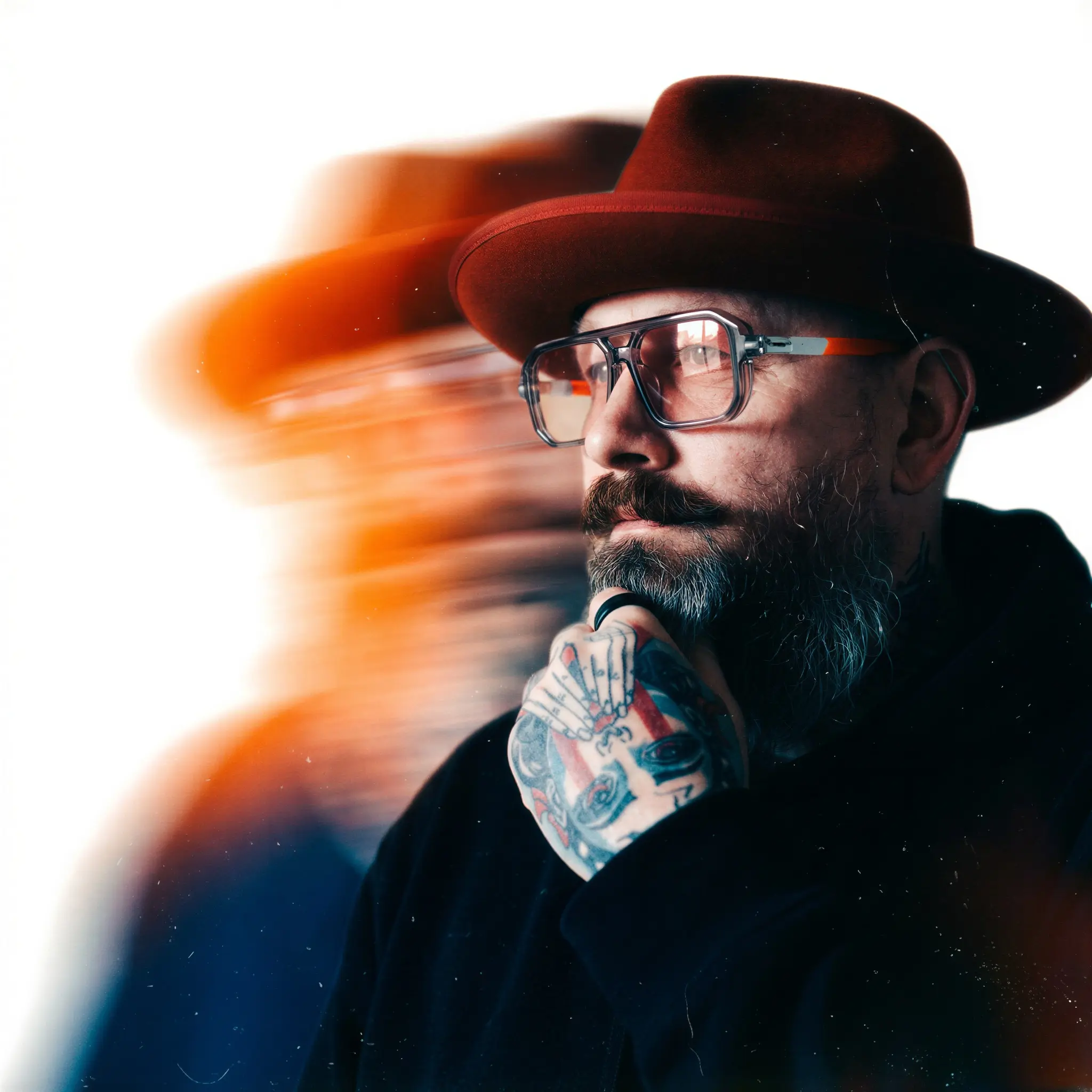 Rich Bennetts in a red hat and glasses, half his face dissolving into motion blur